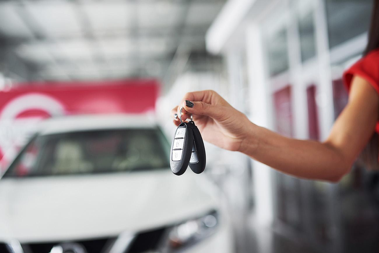 Passing car keys. Cropped closeup of a car dealer holding out car keys to the camera copyspace car dealership salon manager salesman selling buying giving owner profession purchase vehicle concept